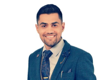 Sam Sinjari, a young man with dark hair, dark eyes and a goatee.