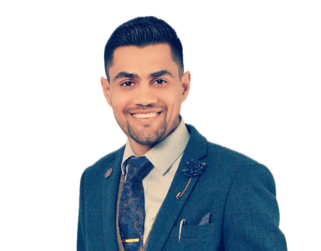 Sam Sinjari, a young man with dark hair, brown eyes and a goatee. 